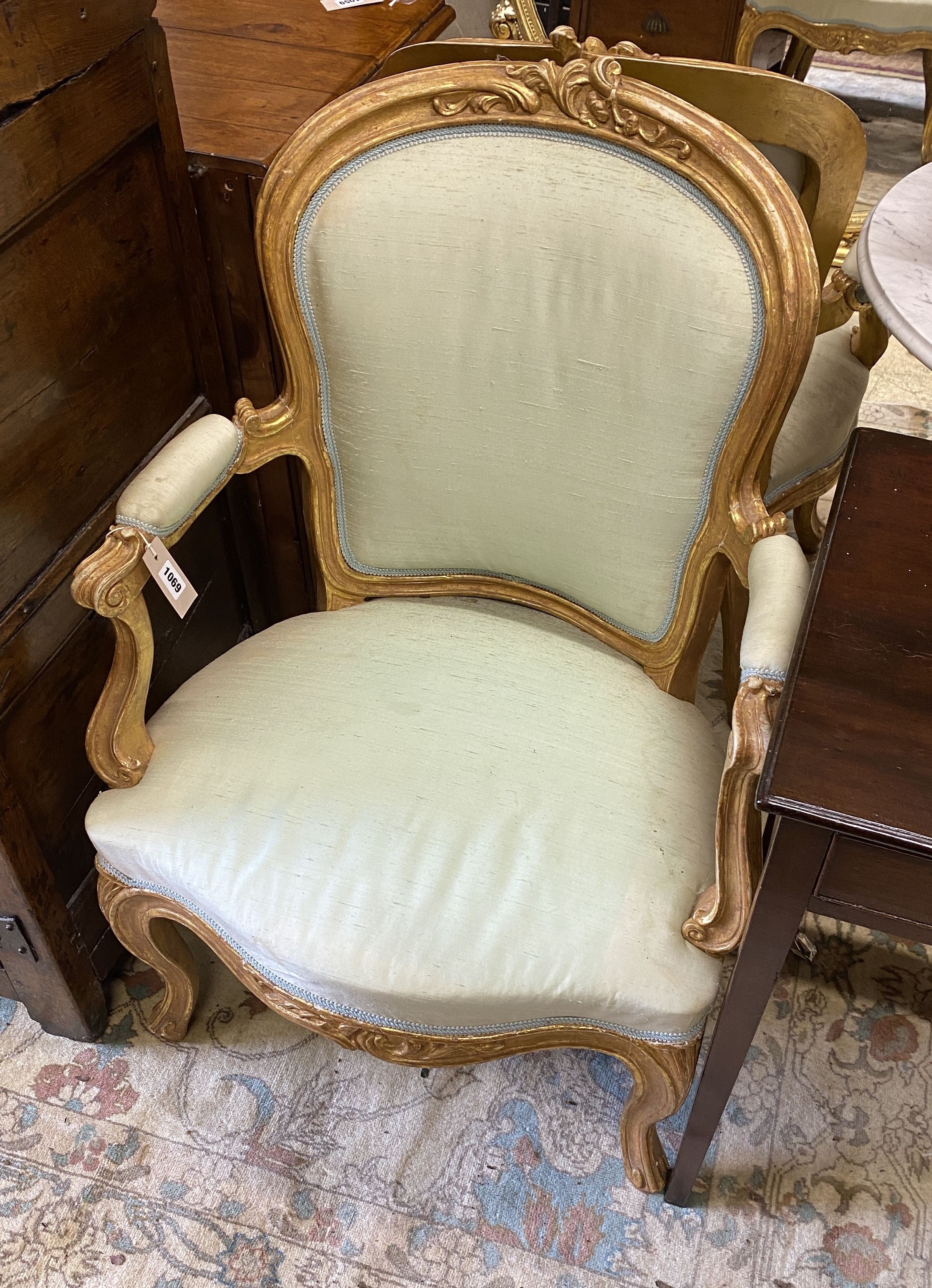 A pair of 19th century Louis XV design carved giltwood fauteuils, width 64cm, depth 50cm, height 94cm